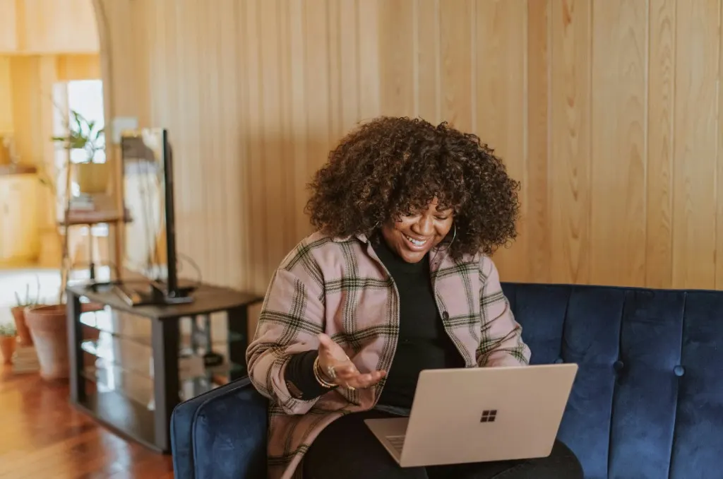 Woman smiling during a virtual nutrition session from her living room